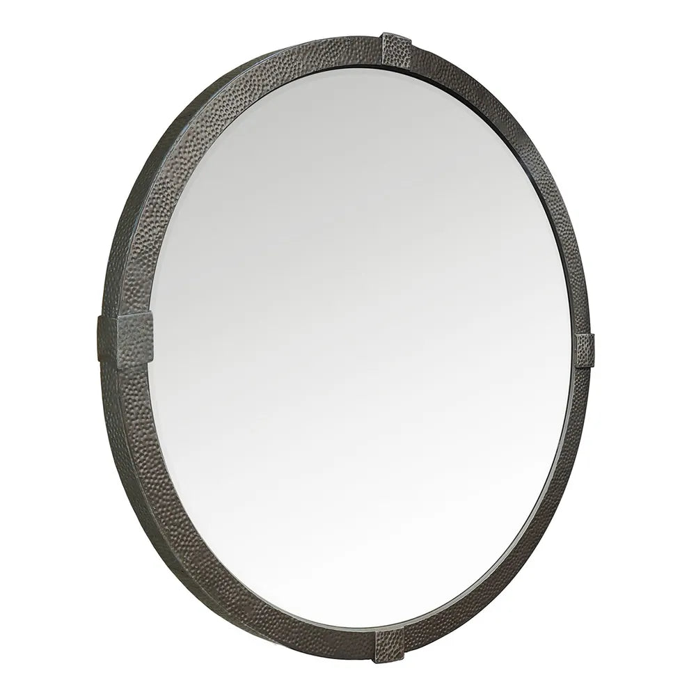 Round mirror with textured bronze iron frame on a white background