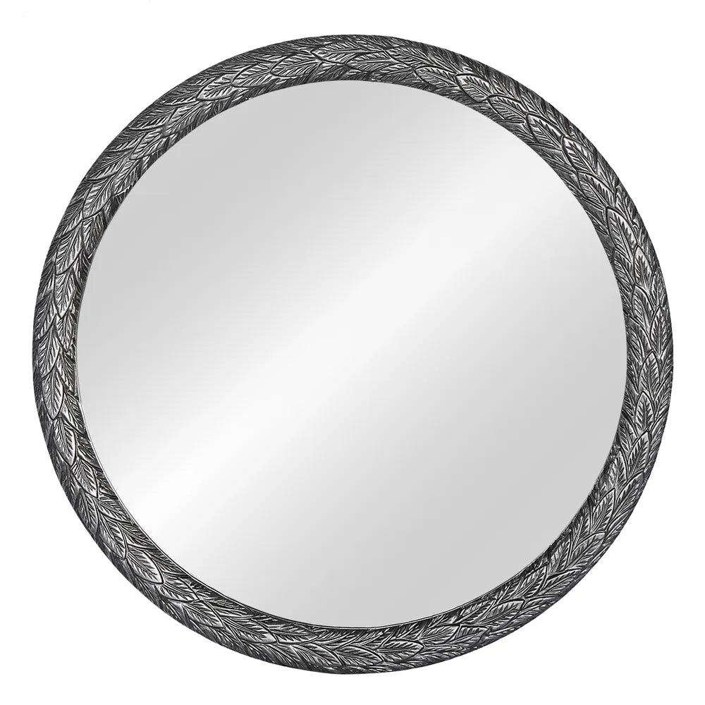 Round mirror with decorative black frame on a white background