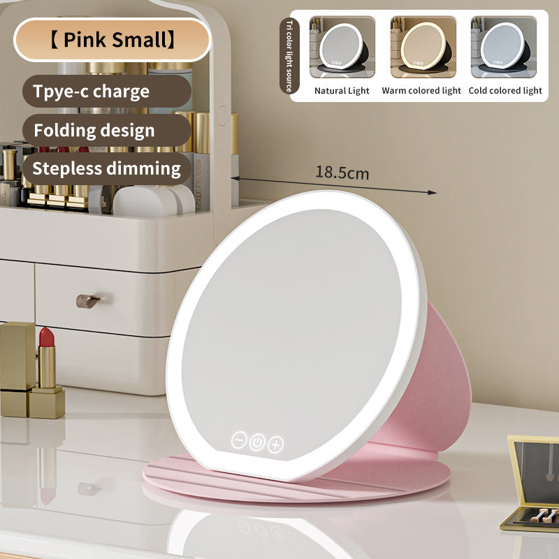 Pink LED makeup mirror with charging cable on a vanity table