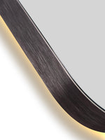 Close-up of a circular mirror with a metallic frame on a white background