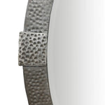 Close-up of a textured metal mirror frame on a white background