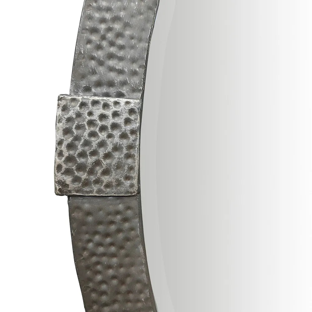 Close-up of a textured metal mirror frame on a white background