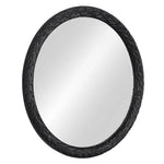 Round mirror with decorative black frame on a white background