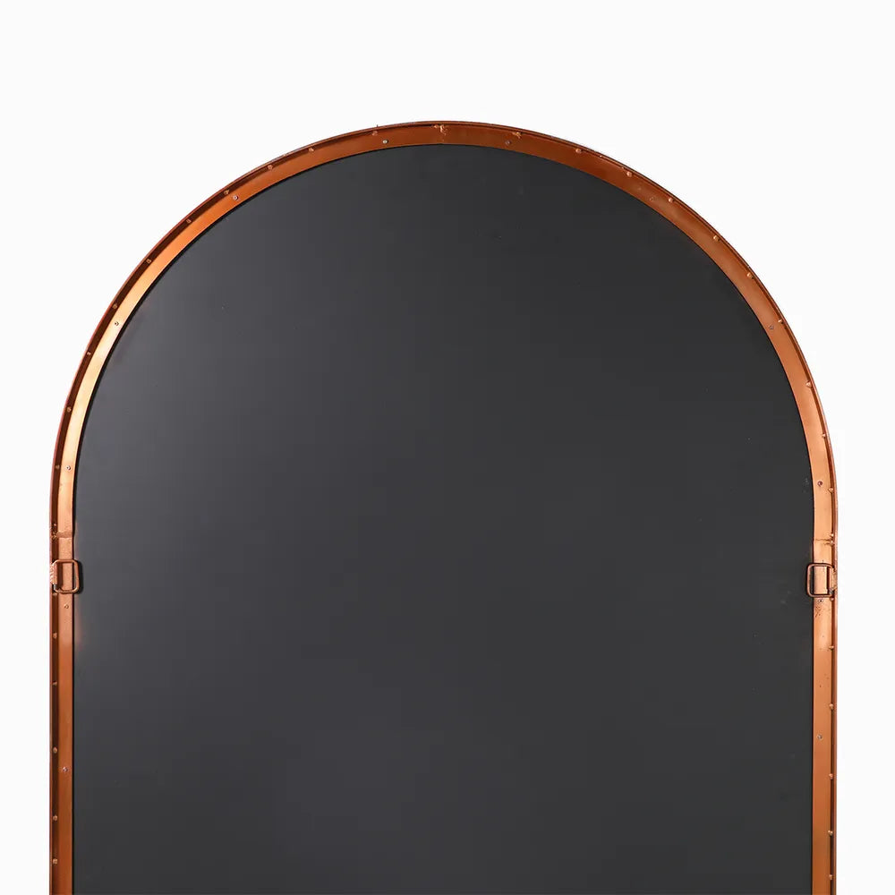 Arched mirror with a bronze frame on a white background