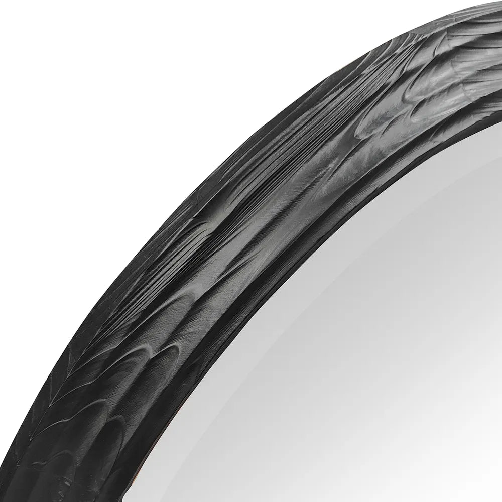 Penrose Wall Mirror Close-up of a black mirror frame with tread pattern on a white background